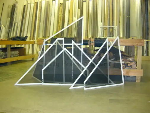 Triangular and gable-shaped Simplicity frames assembled on a workshop bench