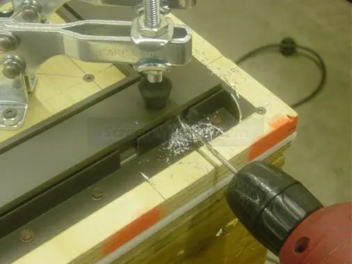Step 6: Install one assembly screw into the drilled hole.