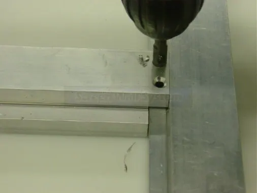 Step 5: Drill two holes at each end of the divider extrusion using the #27 drill bit. Holes are positioned 3/16" in fr