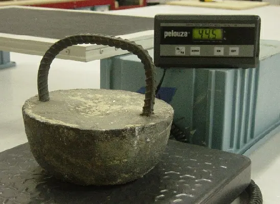 A cast weight resting on a digital scale during static load testing
