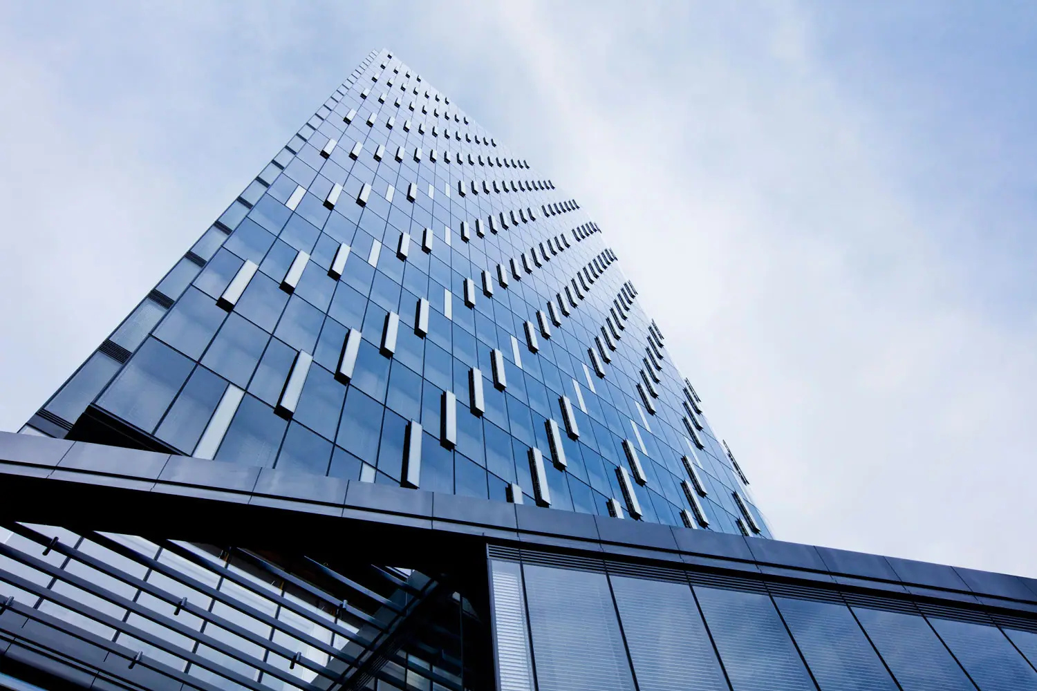 The tapering glass facade of PNC Tower in Pittsburgh, its ventilation openings fitted with screen panels